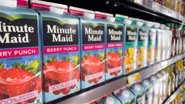 Close up of Minute Maid juice products on a grocery store shelf, representing the Coca-Cola class action lawsuit.