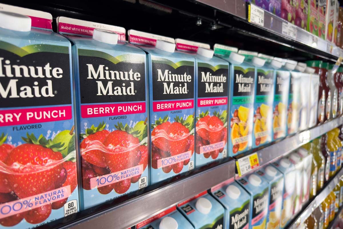 Close up of Minute Maid juice products on a grocery store shelf, representing the Coca-Cola class action lawsuit.