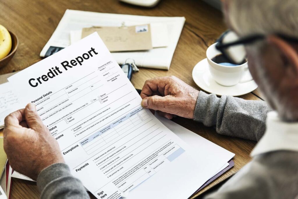 An elderly man reading his credit report, representing the CoreLogic Credco FCRA class action lawsuit settlement.