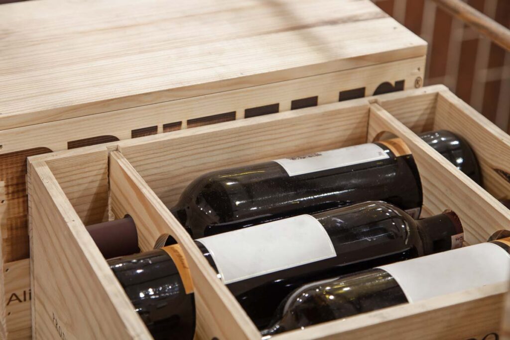 Close up of wine bottles in a box for delivery, representing the Southern Wine and Spirits class action lawsuit settlement.