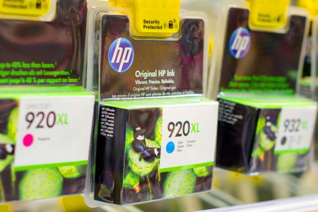 Close up of HP ink cartridges for sale in a store, representing the HP monopoly class action.