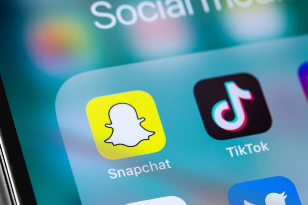 Close up of Snapchat and TikTok app icons displayed on a smartphone screen, representing the Snapchat and TikTok social media lawsuit.