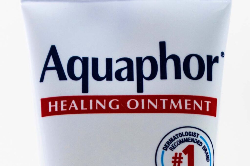 Close up of Aquaphor logo, representing the Aquaphor lip repair class action.