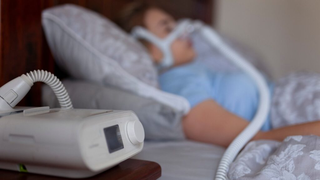 Woman sleeping with cpap machine