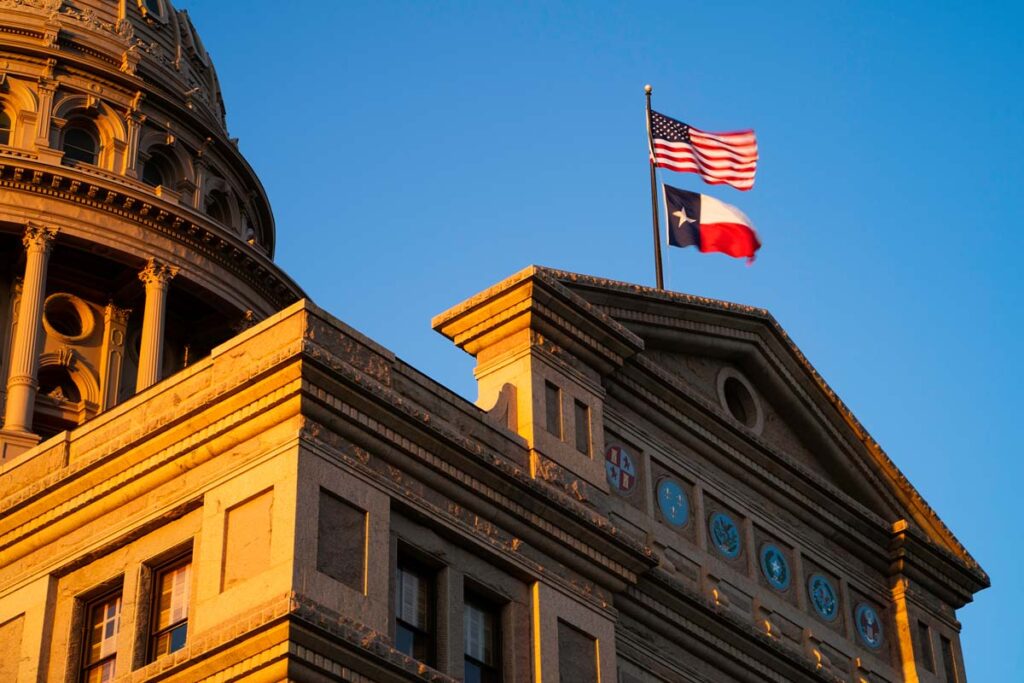 Texas Capitol building at sunset, representing the lawsuit over the Texas immigration law.