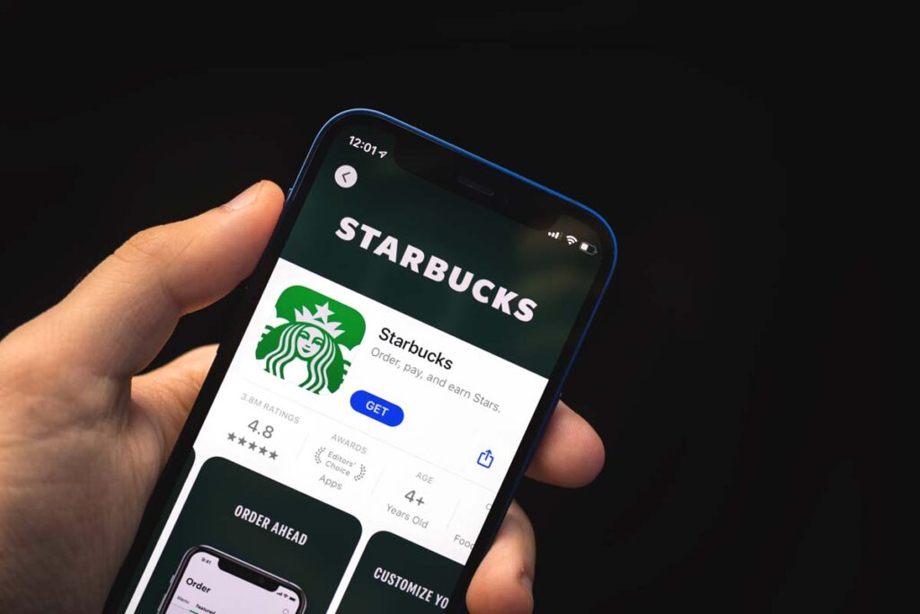 Close up of Starbucks app download page displayed on a smartphone, representing the Starbucks app.