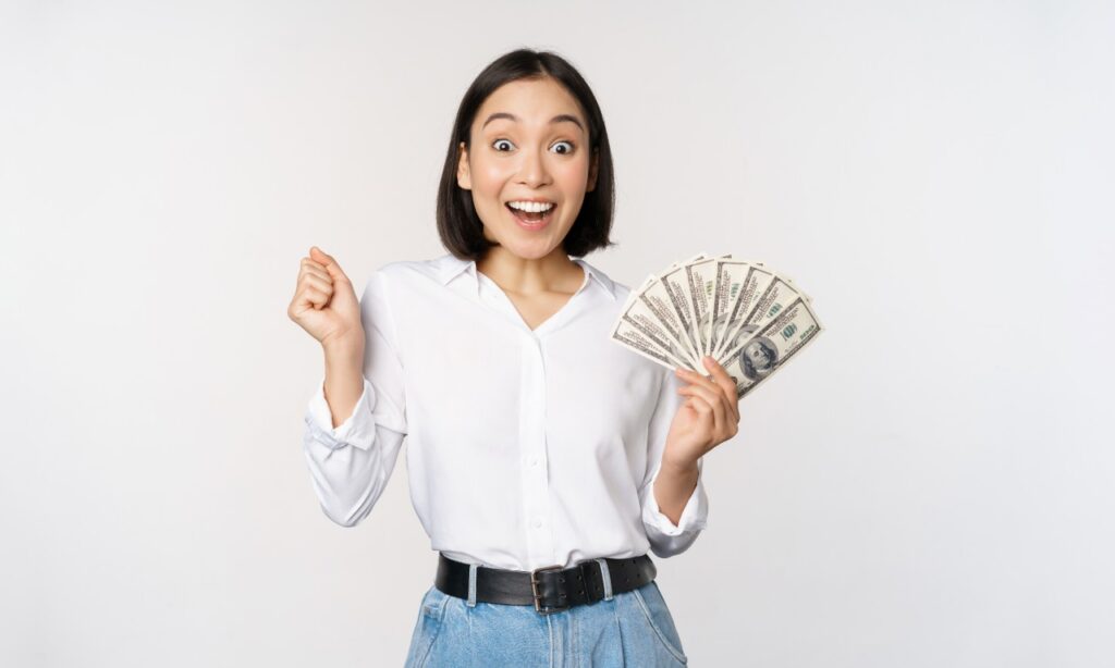 Happy woman with cash in hand, representing recent settlement payments to consumers.