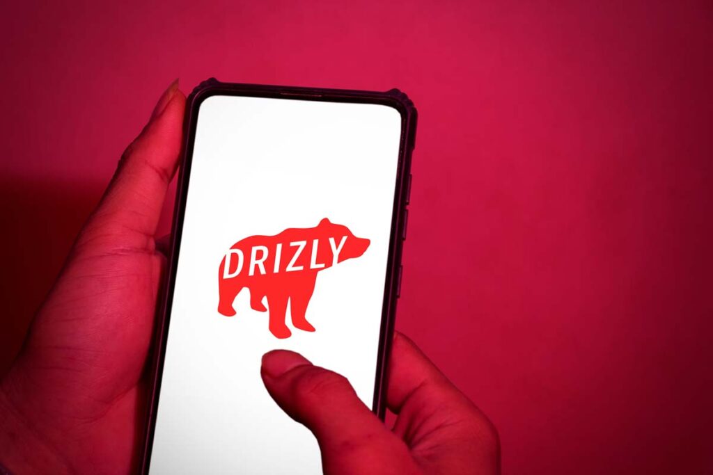 Drizly logo displayed on a smartphone screen, representing the Drizly closing.