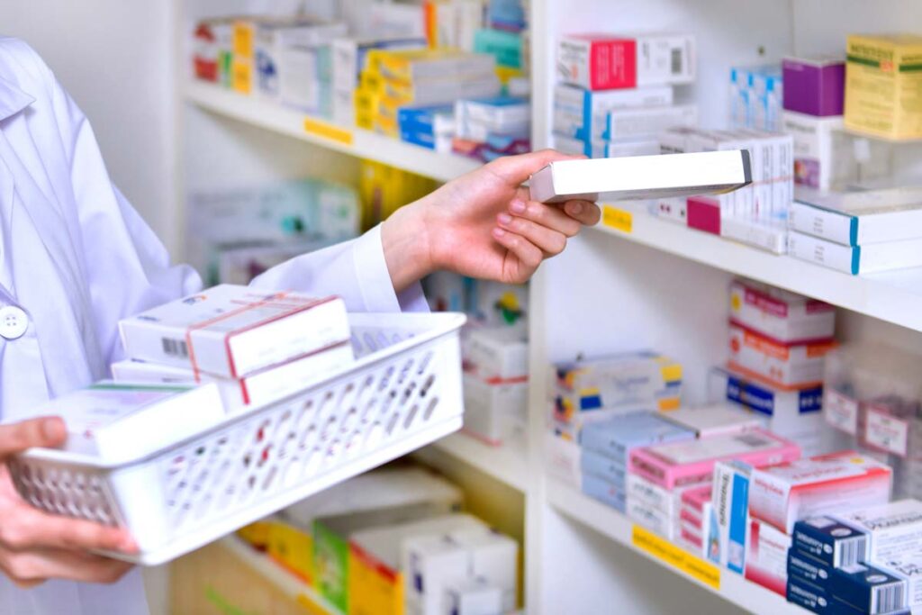 Close up of pharmacist restocking a shelf, representing the generic drug settlement.