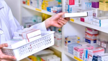 Close up of pharmacist restocking a shelf, representing the generic drug settlement.