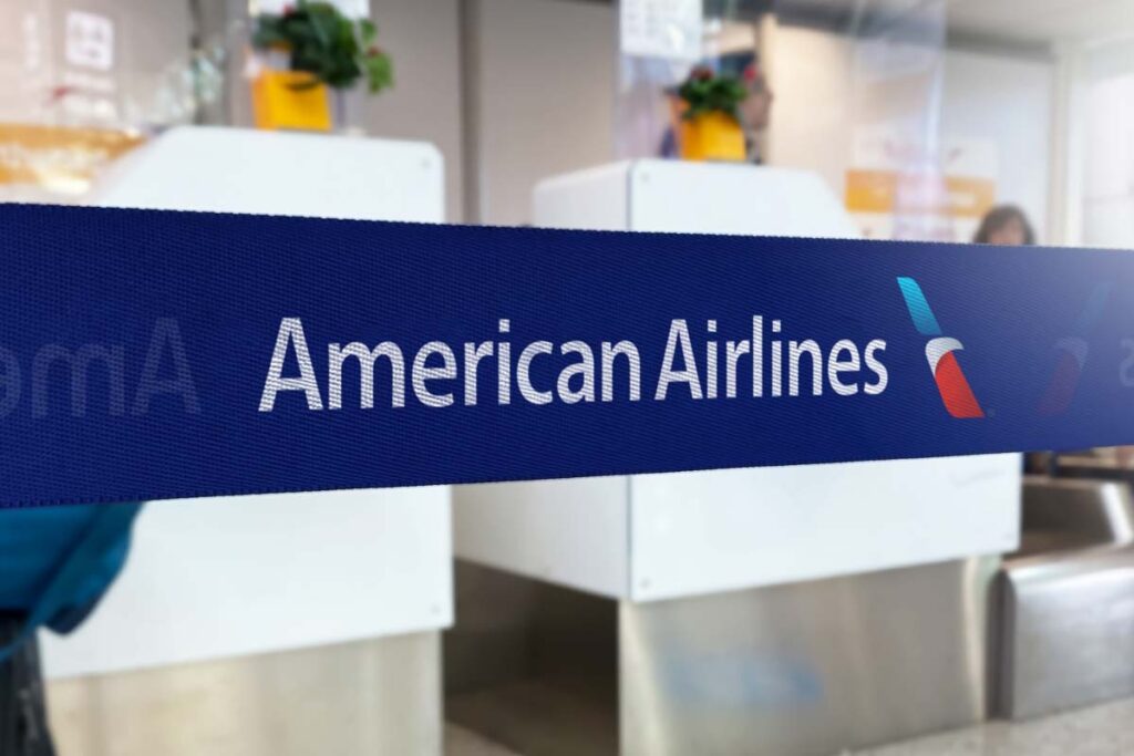 American Airlines logo on barrier tape in an airport, representing the American Airlines class action.