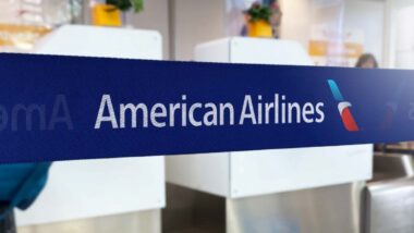 American Airlines logo on barrier tape in an airport, representing the American Airlines class action.
