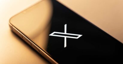 Close up of X Corp logo displayed on a smartphone screen, representing the X class action lawsuit.