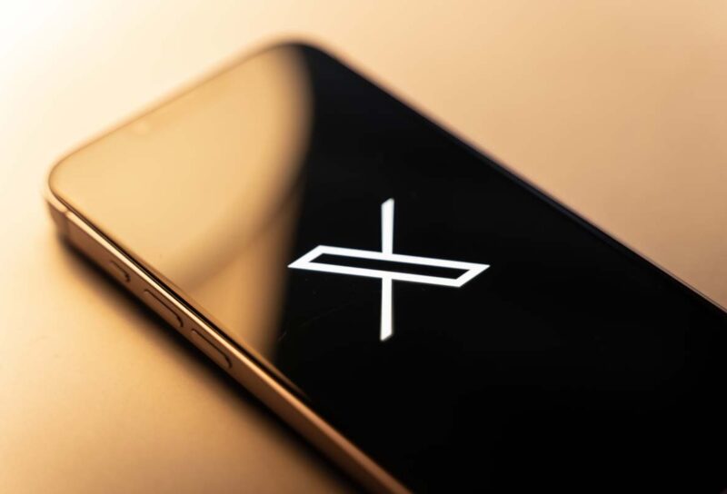 Close up of X Corp logo displayed on a smartphone screen, representing the X class action lawsuit.