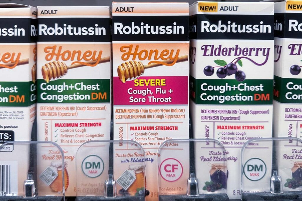 Robitussin products on a supermarket shelf, representing the Robitussin Honey recall.