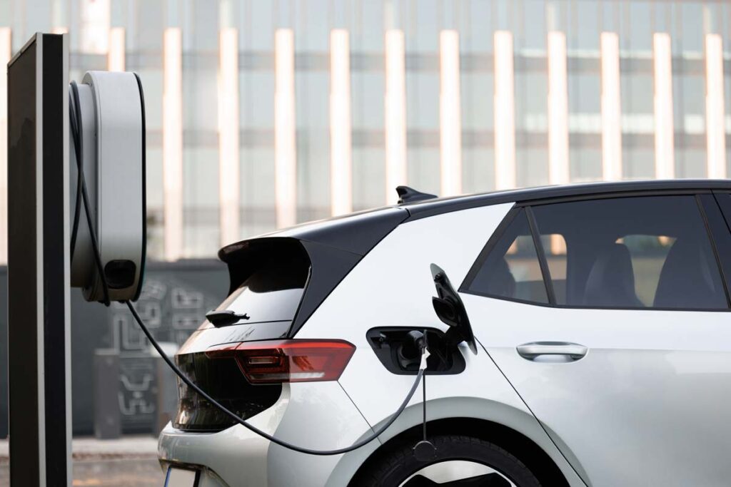 An automobile at an electric charging station, representing EV tax credits in 2024.