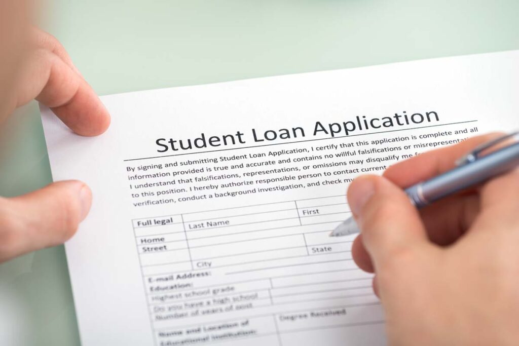 Close up of a student filling out a student loan application, representing the MOHELA PSLF class action lawsuit.