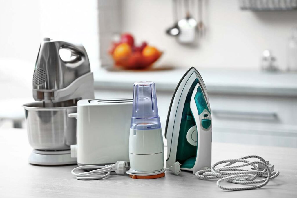 Household products on a kitchen counter (iron, blender, etc), representing recent recalls on household products.