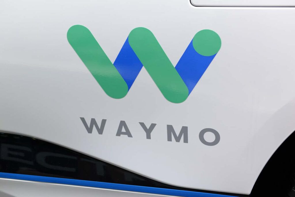 Close up of Waymo logo on the side of a vehicle, representing the Waymo recall.