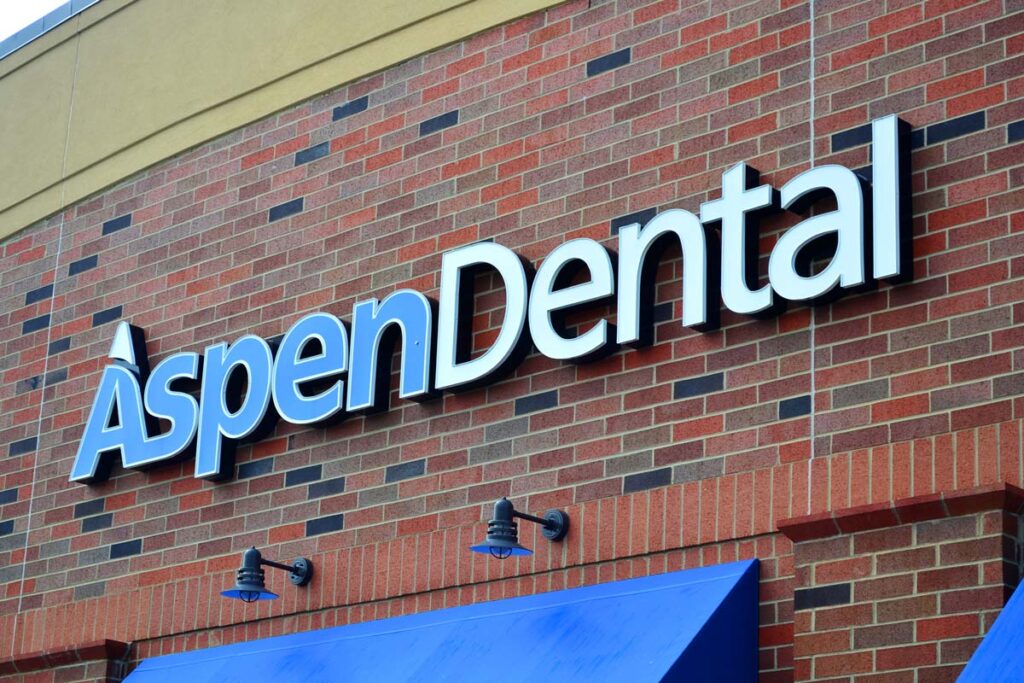 Close up of Aspen Dental signage, representing the Aspen Dental Management class action lawsuit settlement.