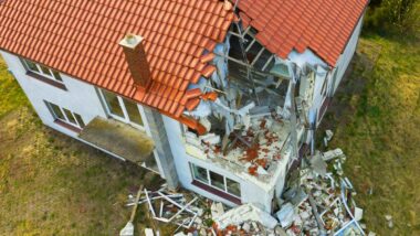 Aerial view of a home with structural damage, representing the Auto-Owners (Mutual) Insurance settlement.
