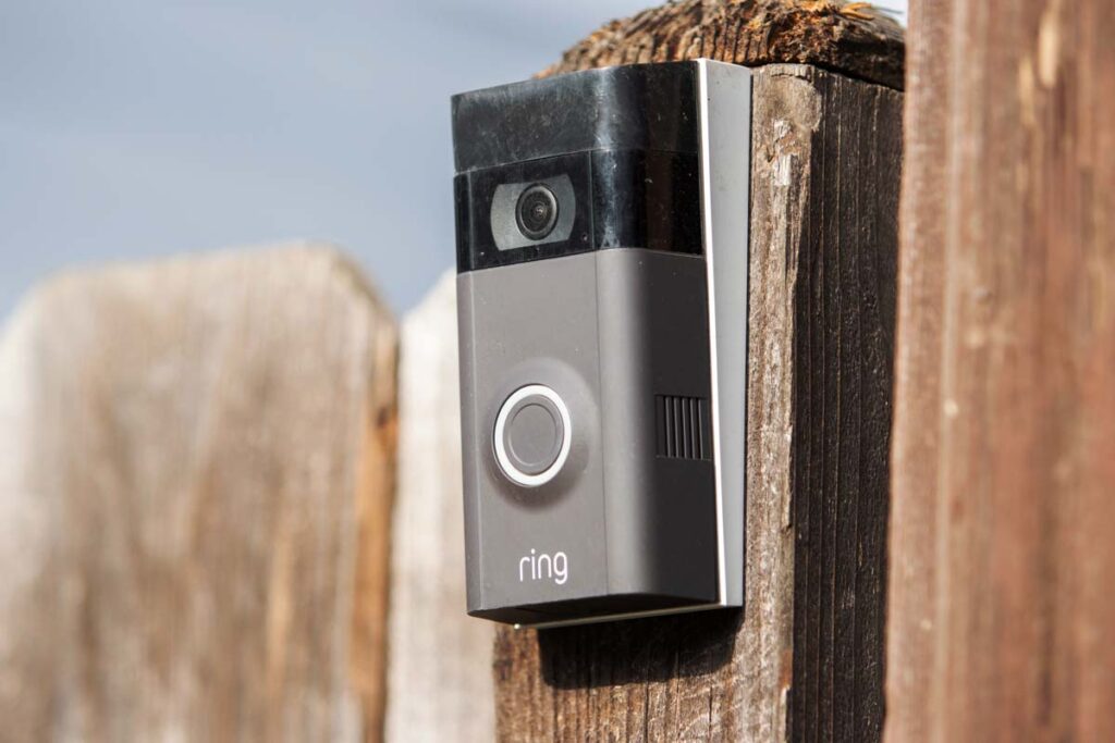 An Amazon Ring doorbell attached to a fence, representing Amazon Ring video.