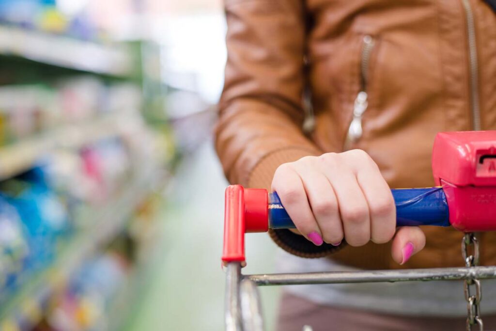 Close up of a womans hands pushing a trolley in a store, representing top recalls for the week of Feb. 12.