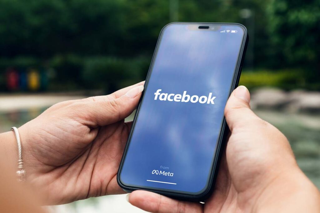 Close up of Facebook logo displayed on a smartphone screen, representing the Facebook user tracking privacy settlement.