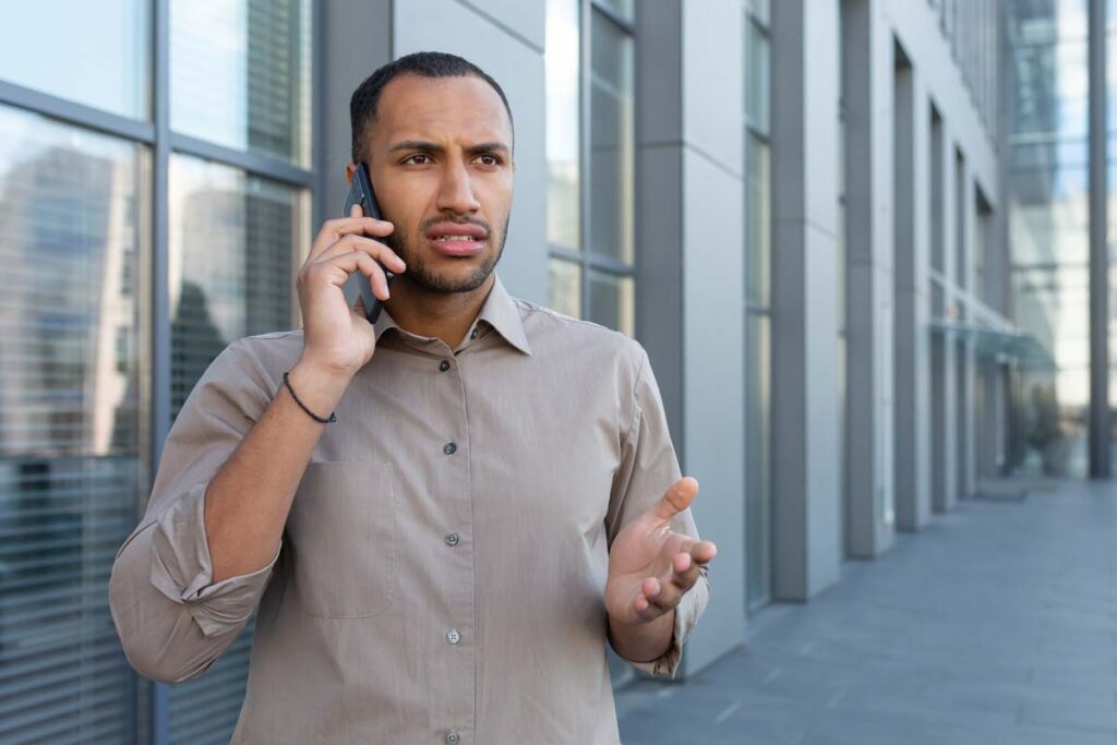 Annoyed man receiving a robocall, representing the Parkway Automotive Group TCPA settlement.