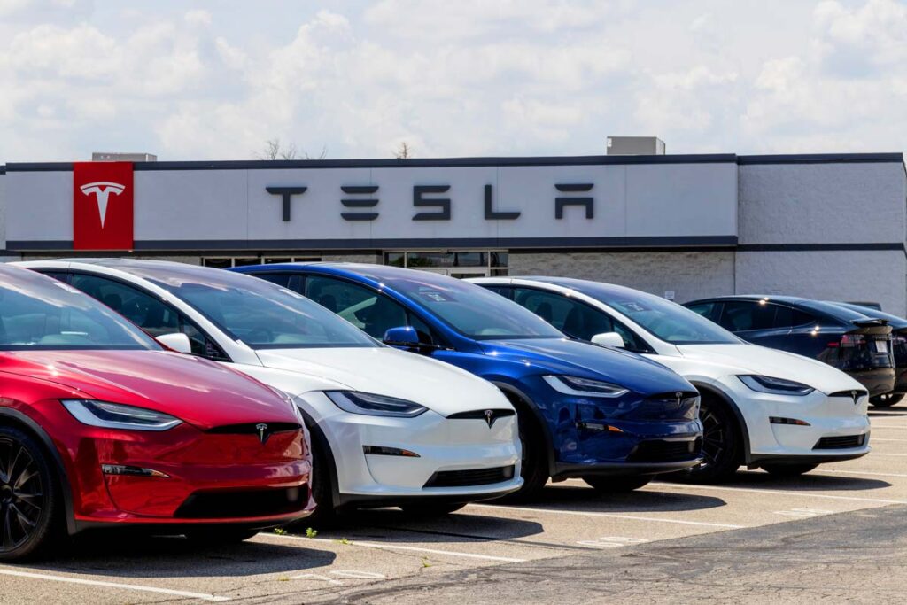 Tesla cars on display at a Tesla dealership, representing the Tesla rearview camera recall.