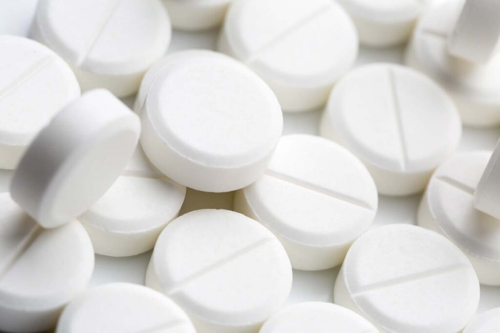 Close up of white round opioid pills, representing the Hikma opioid settlement.