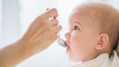 Close up of a baby being fed baby food, representing the baby food class actions.