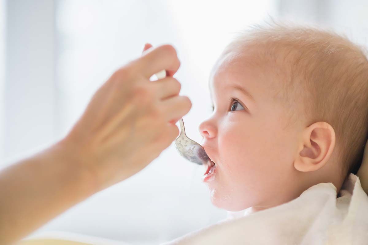 Close up of a baby being fed baby food, representing the baby food class actions.