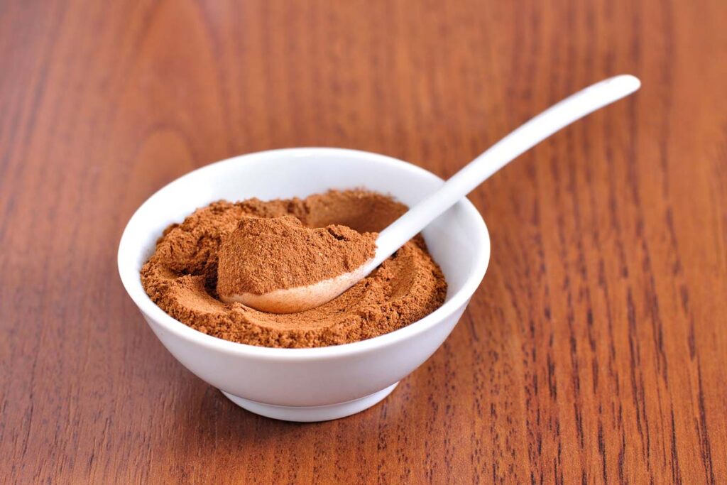 Close up of powder cinnamon in a small bowl, representing the cinnamon recalls.