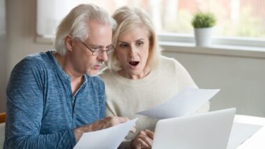 Shocked retirees looking at retirement funds.