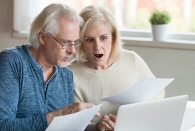 Shocked retirees looking at retirement funds.