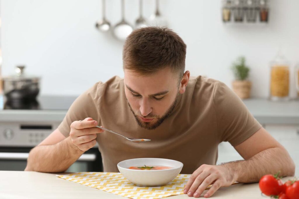 A man eating soup, representing the Campbell Soup class action.