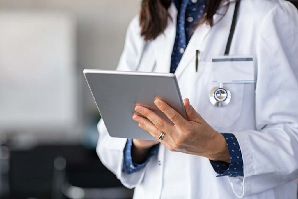Close up of a female doctor using a tablet, representing the Roper St. Francis Healthcare data breach settlement.