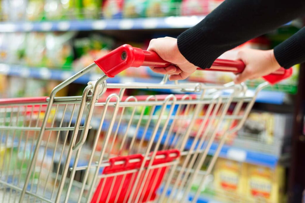 Close up of a woman pushing a shopping cart in a supermarket, representing top recalls for the week of March 11.