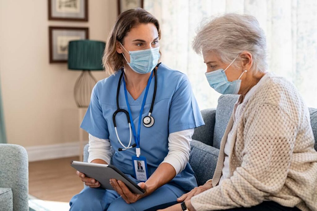 Home health nurse using a tablet with a patient, representing the Personal Touch data breach class action lawsuit settlement.