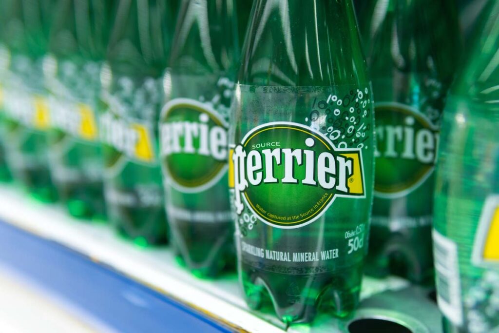 Close up of Perrier water bottles on a supermarket shelf, representing the Perrier class action.