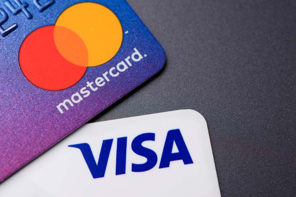 Close up of Visa and Mastercard logo on credit cards, representing the Visa and Mastercard settlement.