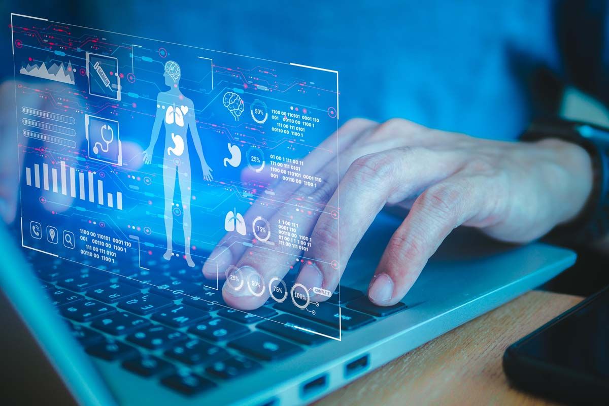 Close up of a medical professional typing on a laptop with a patient data concept overlay, representing the Change Health Care cyberattack.