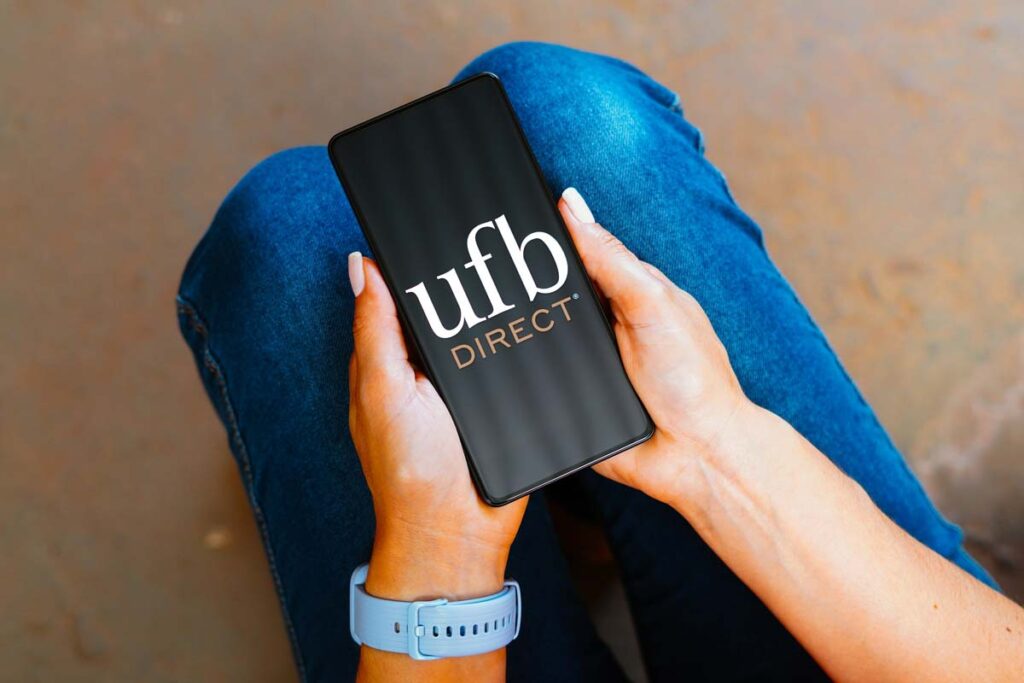 UFB direct logo displayed on a smartphone screen, representing the UFB class action involving current interest rates.
