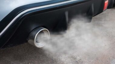 Close up of a car tailpipe emitting exhaust, representing the tailpipe pollution rules.