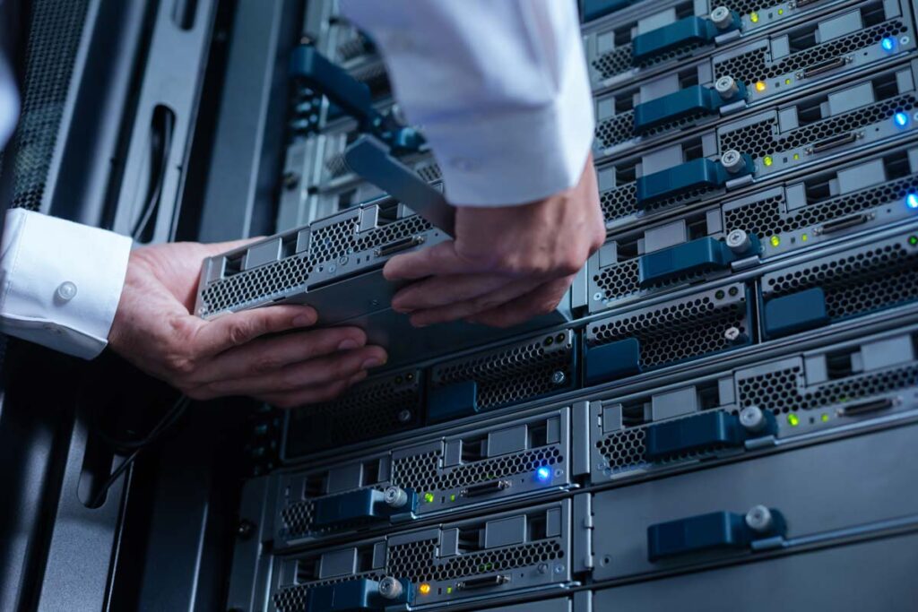 Close up of an IT worker replacing a server, representing the American Vision Partners data breach.