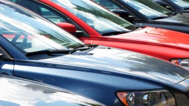 Close up of a line of cars, representing auto recalls.