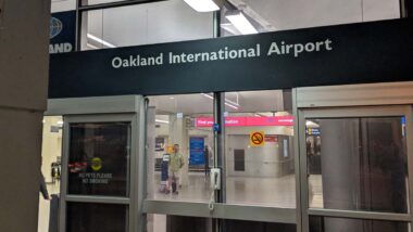 Close up of Oakland International Airport entrance, representing the potential Oakland airport name change.
