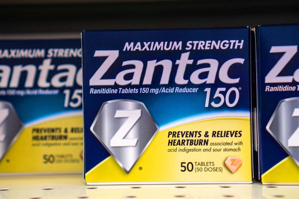 Close up of Zantac products on a supermarket shelf, representing the Zantac cancer settlement.