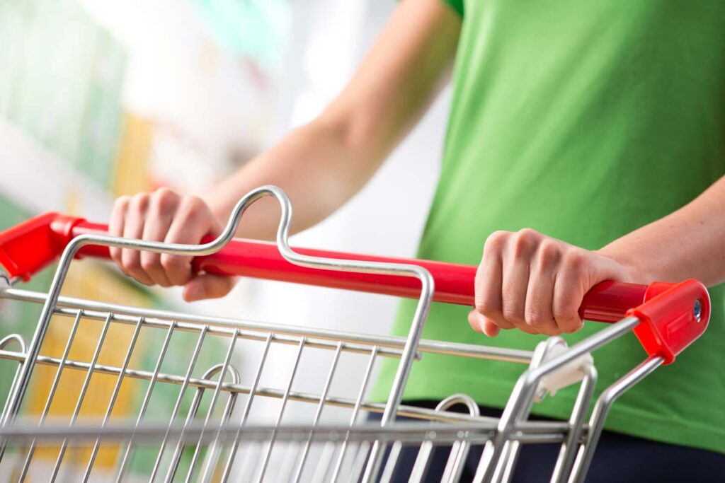 Close up of a woman pushing a shopping cart, representing top recalls for the week of March 25.